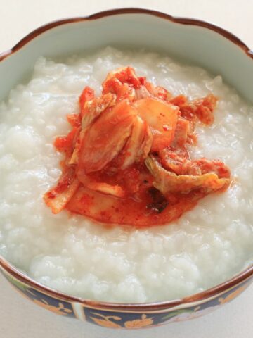 A nice bowl of Korea porridge with kimchi toppings.