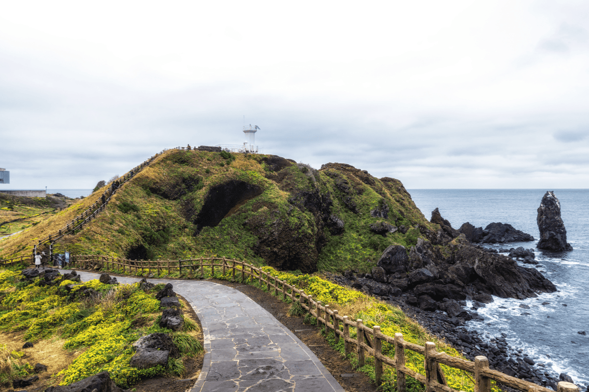 Seopjikoji Light House along with coastal lines in Jeju Island, South Korea.