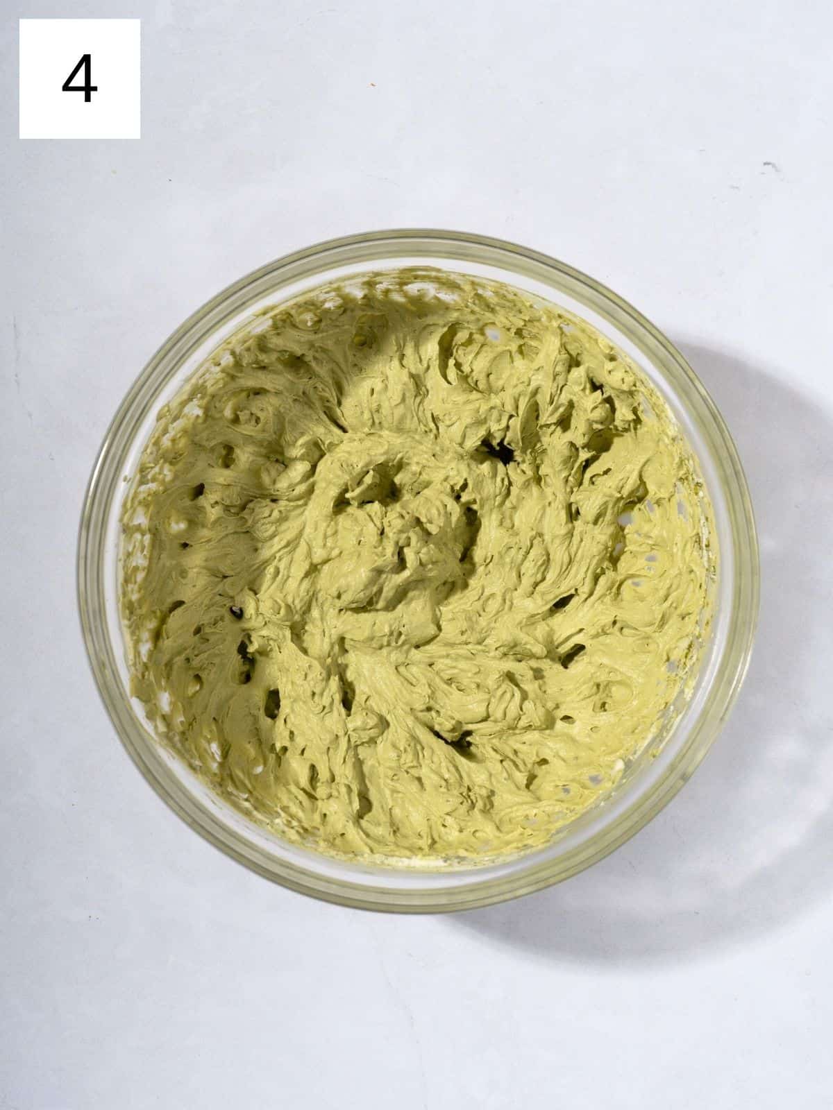 A bowl filled with matcha whipped cream.