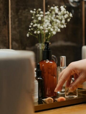 Skincare products on top of bathroom counter.