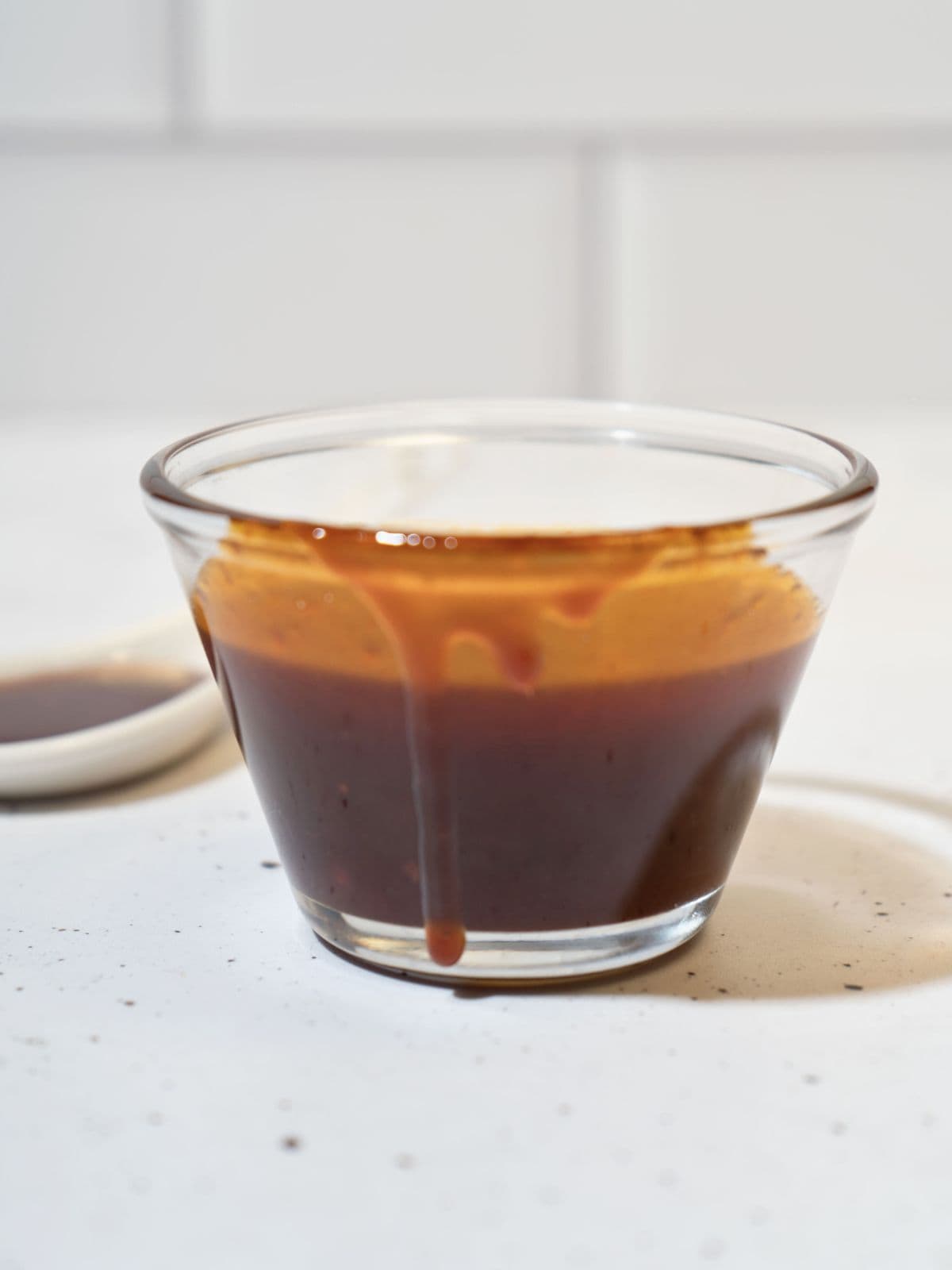 Honey gochujang sauce in a cup.