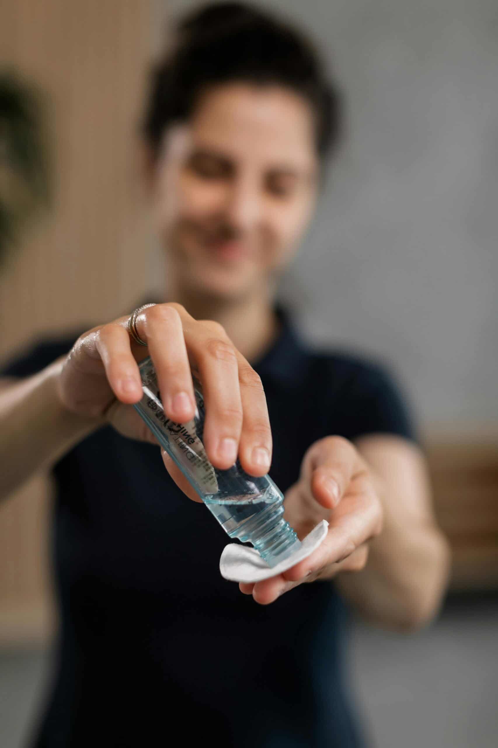 Person putting toner on a cotton pad.