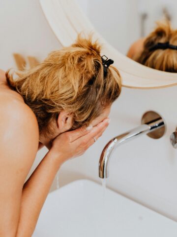 Person washing face.