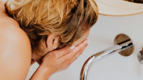 Person washing face.