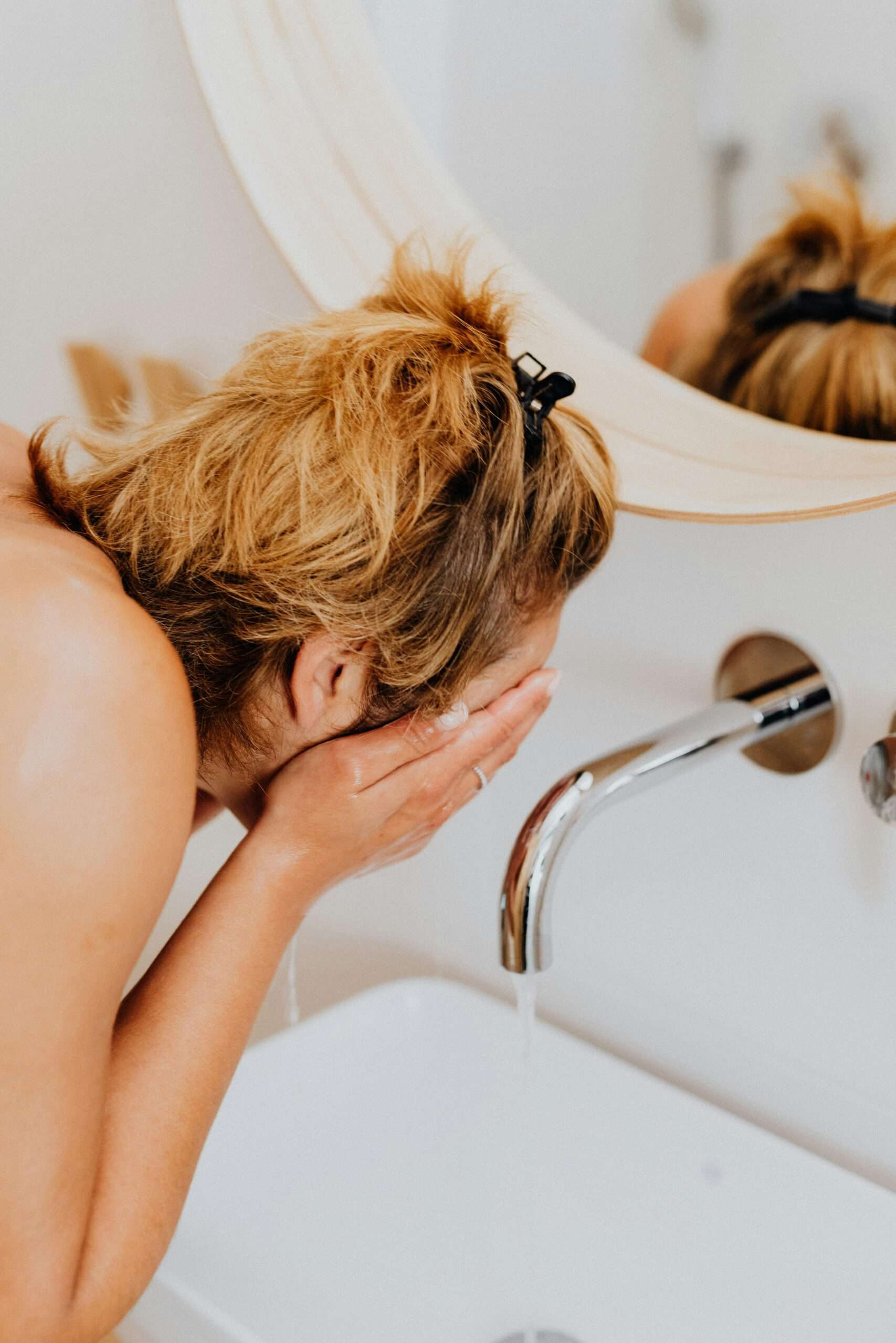 Person washing face.