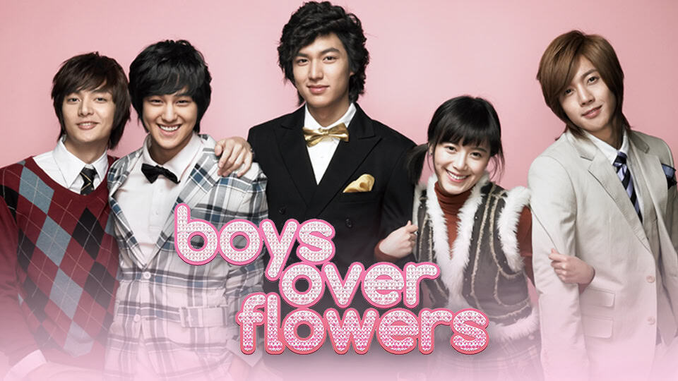 The main cast of Boys Over Flowers posing together against a pink backdrop, featuring the four F4 members and Geum Jan-di smiling, with the series title in pink rhinestone-style font.