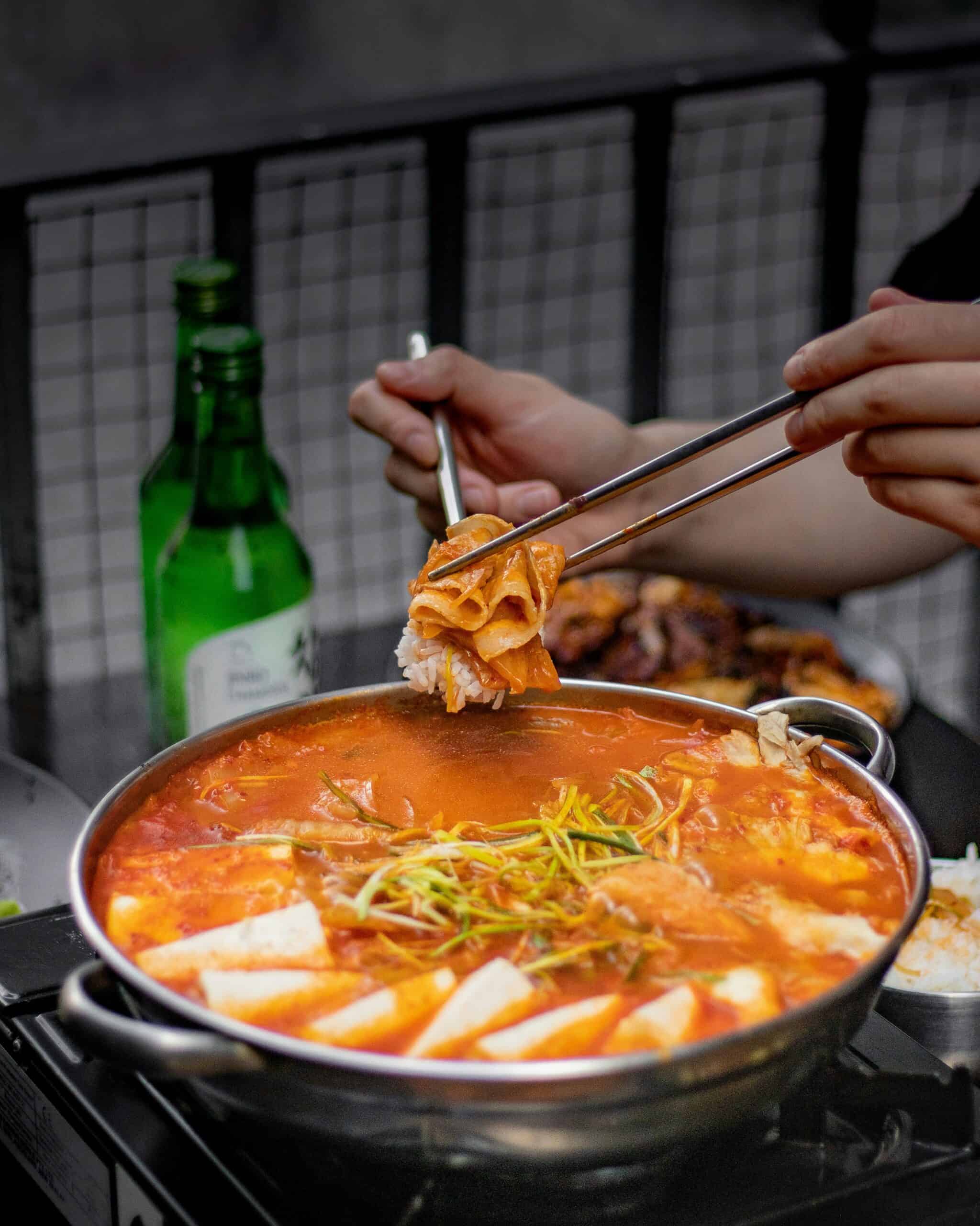 kimchi jjigae on a stainless steel pot.