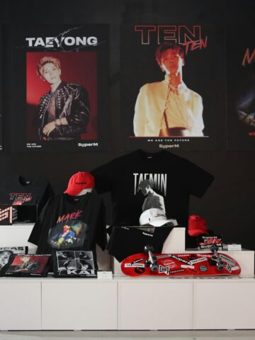 K-pop themed merchandise display with posters, caps, and skateboards in Seoul Korea Asia.
