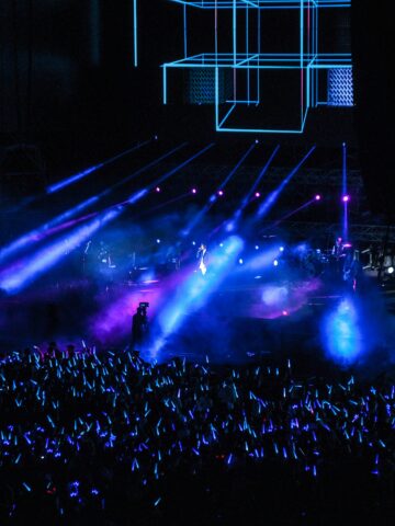 Vibrant neon-lit concert stage with colorful lighting and crowd in Seoul Korea Asia.