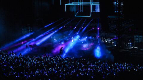 Vibrant neon-lit concert stage with colorful lighting and crowd in Seoul Korea Asia.