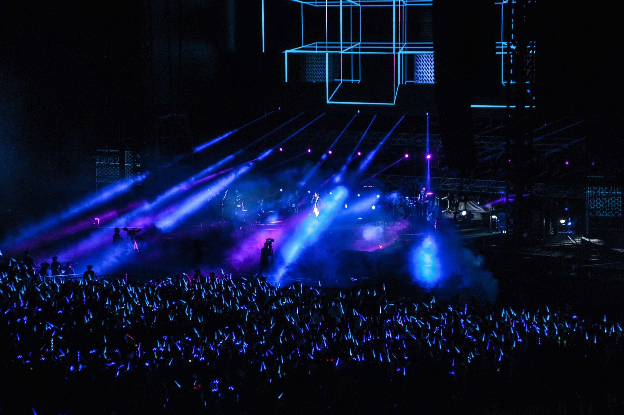 Vibrant neon-lit concert stage with colorful lighting and crowd in Seoul Korea Asia.