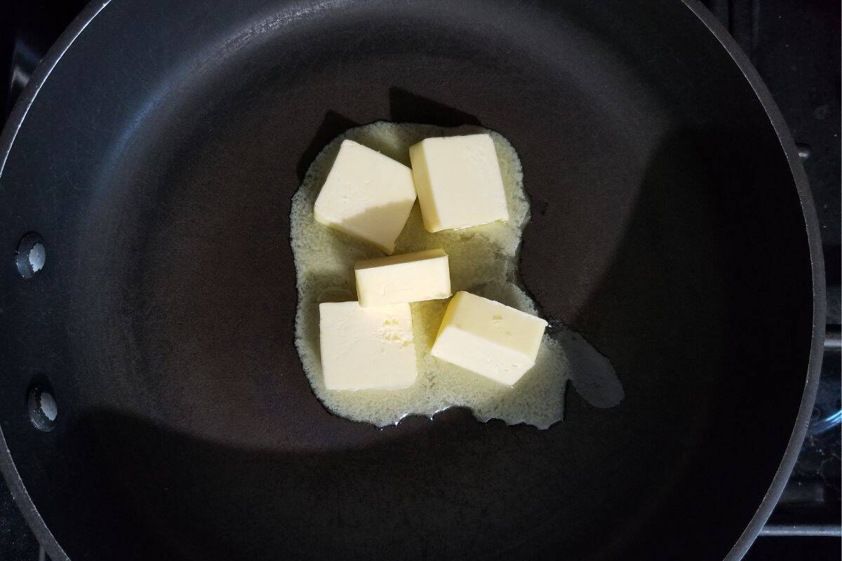 Melting slices of butter in a pan.