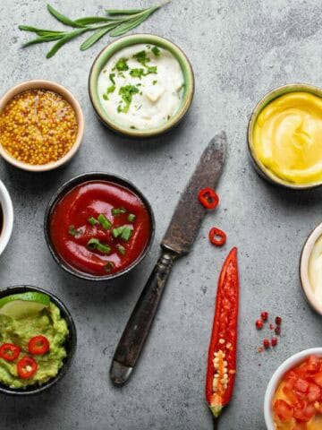 A batch of different Asian sauces in bowls.