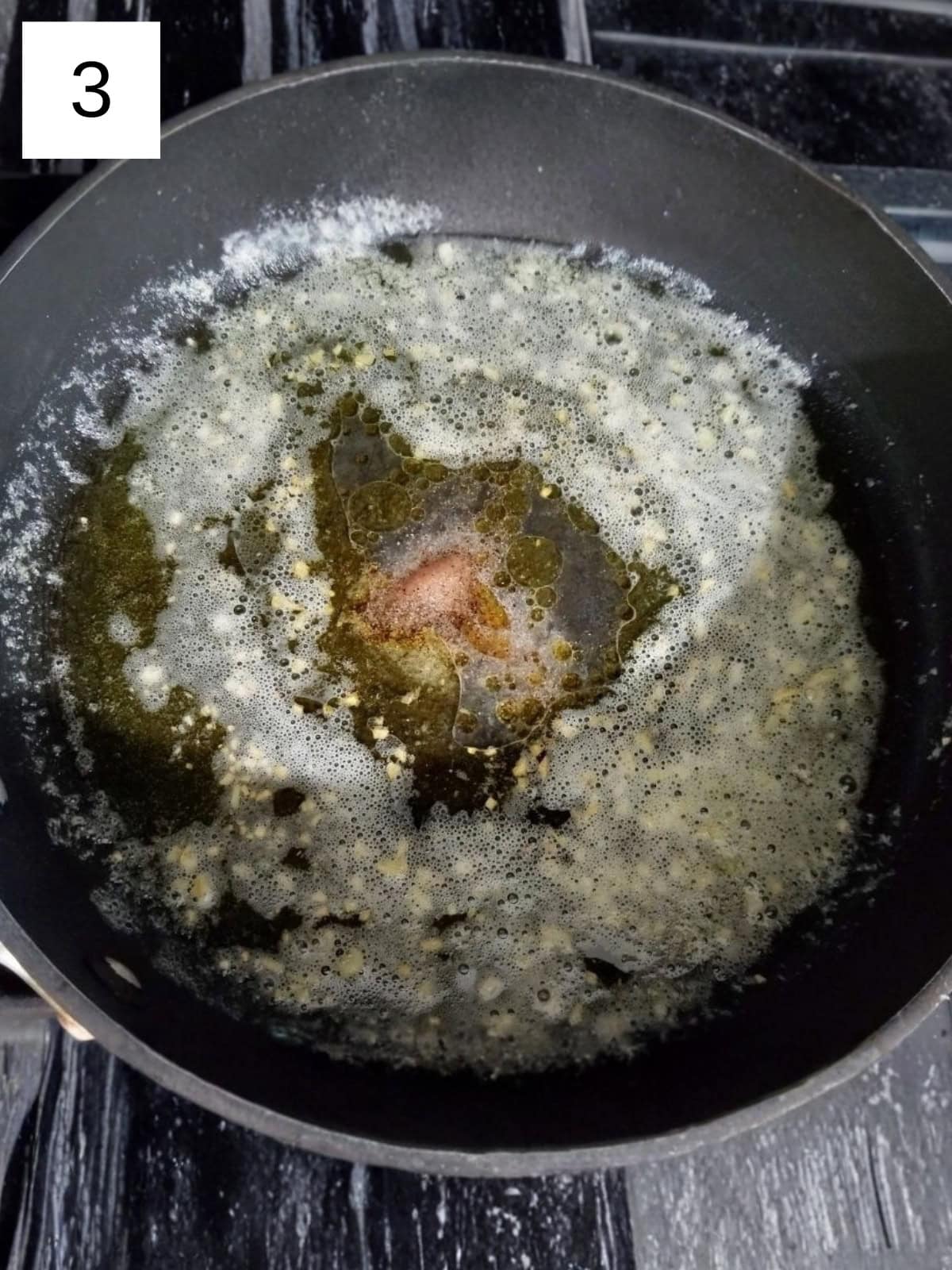 Lemon butter sauce, made with fresh garlic, butter, lemon juice, salt and pepper, in a pan.