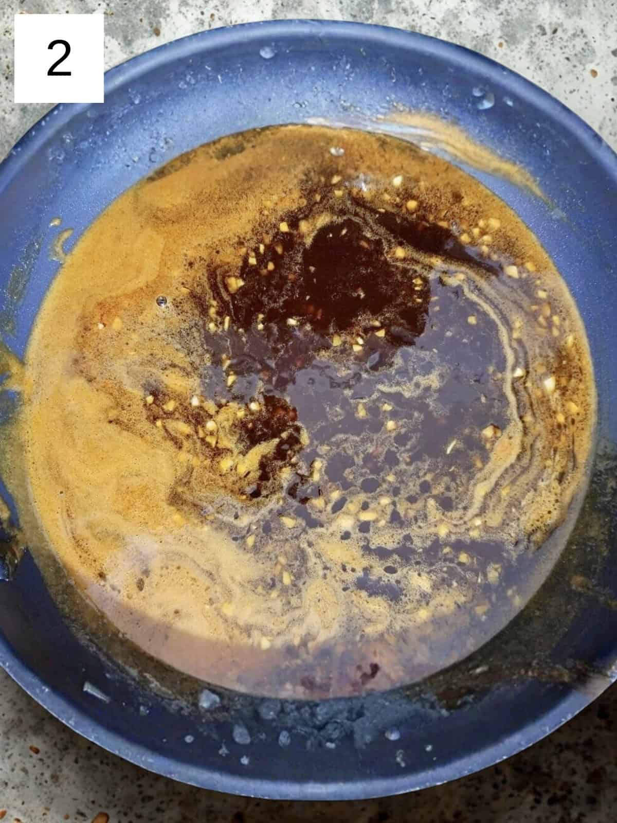 A mixture of honey sriracha sauce in a pan.