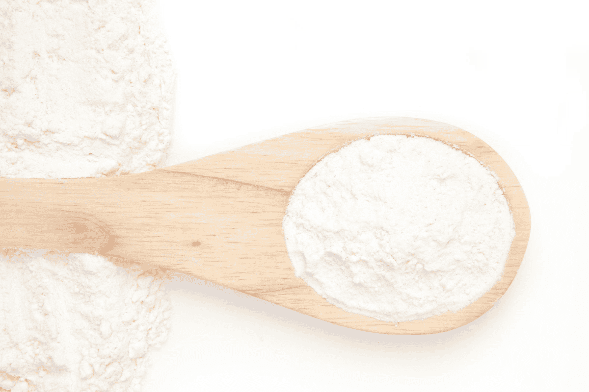 A wooden spool full of arrowroot flour.