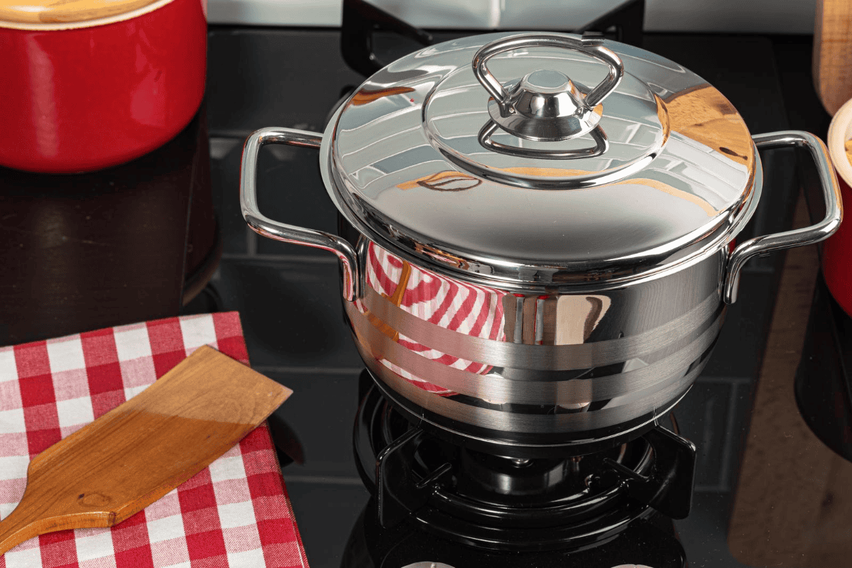 A metal pot on a stove top.