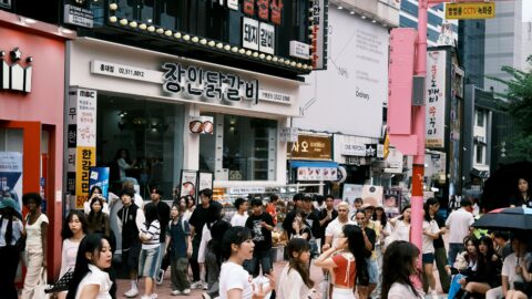 Vibrant street scene in Seoul Korea with dancers performing in busy city center.