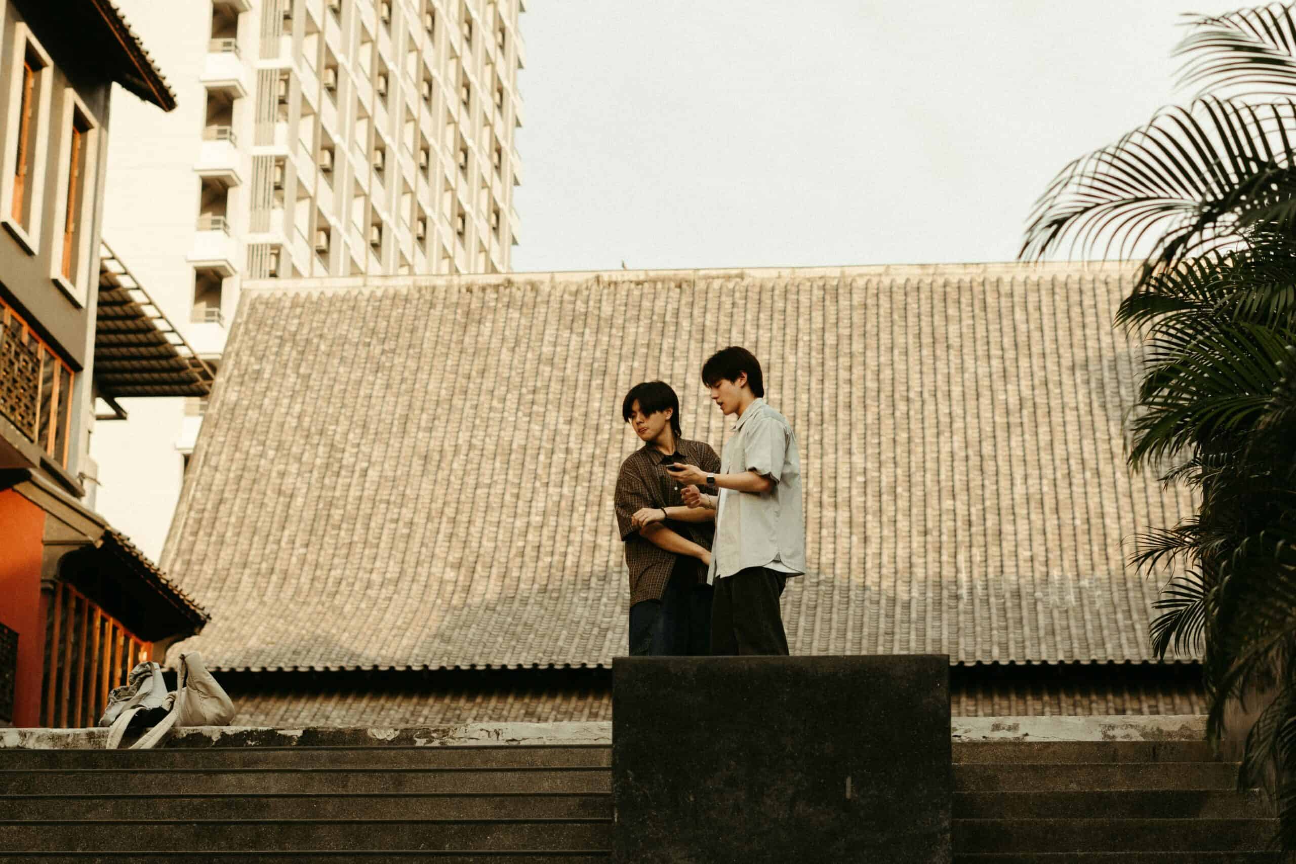 Youthful couple exploring Seoul cityscape, blending traditional architecture with modern urban life.