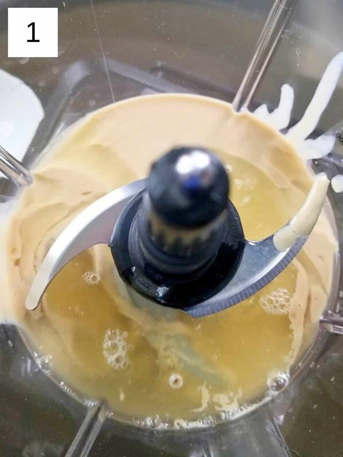 A mixture of ingredients for tahini sauce in a food processor.