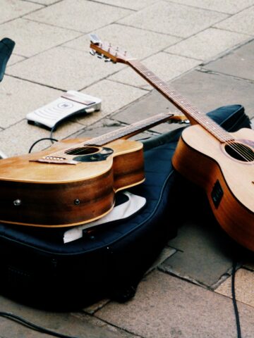 Guitar and accessories placed on the ground in Seoul, perfect for street music and busking scenes.