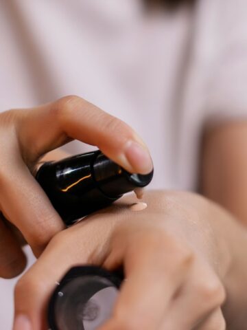 Skincare serum dropper applied to the back of the wrist